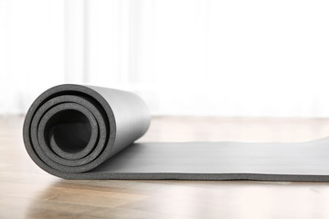 Sticker - Rolled grey yoga mat on floor indoors