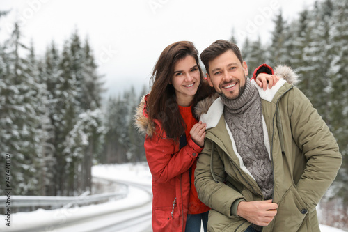 Couple In Warm Clothes Near Snowy Forest Space For Text Winter