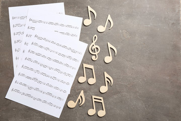 Sticker - Sheets and music notes on color background, top view. Space for text