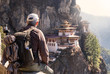 tourist sitting on his back watching tiger`s nest temple in Paro, Bhutan