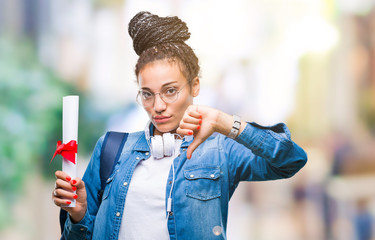 Wall Mural - Young braided hair african american student girl holding degree over isolated background with angry face, negative sign showing dislike with thumbs down, rejection concept