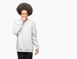 © Krakenimages.com - Young african american man with afro hair wearing sporty sweatshirt feeling unwell and coughing as symptom for cold or bronchitis. Healthcare concept.