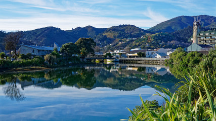 Wall Mural - Panorama of Nelson City, reflected in the Maitai River, New Zealand.