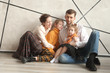 © yurolaitsalbert - happy family sitting on the floor in a new house on Christmas eve