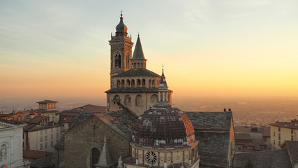 Bergamo, Italy. The old town. Aerial view of the Basilica of Santa Maria Maggiore during the sunset. In the background the Po plain