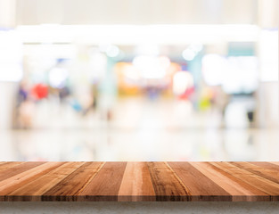 Poster - Empty wood table top with blur department store boekh background,Mock up template for display or montage of product or content use as banner in social media ads.