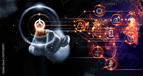 Fotografía Finger pressing power button with energy resources icon on earth at night background