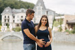 © Aleksandr - Pregnant woman and her husbant hug each other and smile. Man put his hand of belly of pregnant woman. Six months of pregnancy