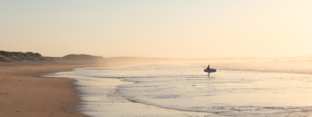 Peniche - Portugal - 26 September 2018 - Surfer running on the beach