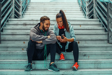 Young Couple Choosing Music Before Running
