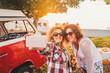 © simona - Nice attractive couple of middle age woman travel together with old red van vintage and take selfie with modern phone during outdoor picnic leisure activity - sunny day of summer vacation