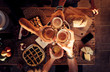 © simona - People eat mixed meals at festive table served for party. Friends celebrate with food on wooden table top view. Happy company having lunch, clinking glasses - outdoor friendship concept