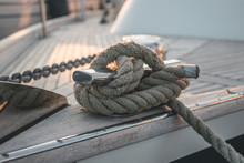 Close-up Of Detailed Knotted Rope On A Luxury Wooden Sailboat Yacht Laying In A Harbour