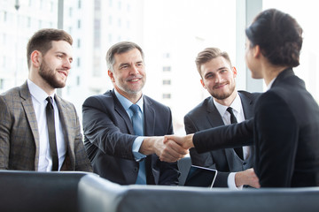 Poster - Business people shaking hands, finishing up a meeting.