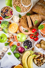 Wall Mural - Healthy food. Selection of good carbohydrate sources, high fiber rich food. Low glycemic index diet. Fresh vegetables, fruits, cereals, legumes, nuts, greens.  copy space