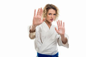 Wall Mural - Portrait of female wearing martial arts uniform making stop gesture