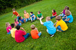 © IdeaBug, Inc. - Group of Kids Playing a Game in a Circle Outside