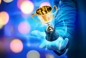 Wall Mural - trophy and particle smoke effect on winner 's hand in party background