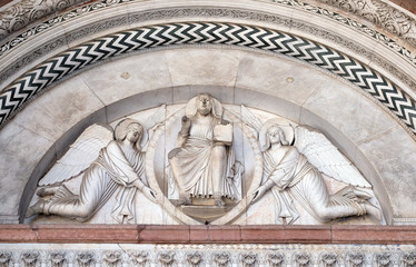 Wall Mural - The central portal of the Cathedral of St Martin in Lucca. Redeemer in a mandorla held by two angels, Lucca, Italy