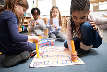 Students Playing Math Game With Plastic Blocks