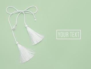 White silk tassels isolated on simple background for creating graphic concepts