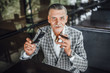 © Тарас Нагирняк - Stylish senior looking to the camera and holding cuban cigarette