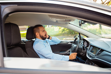 Worried businessman stucking in traffic jam