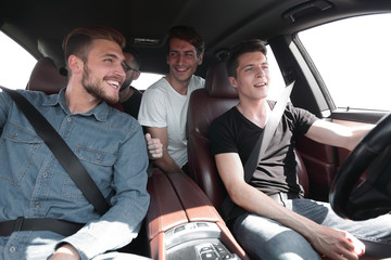 close up. a group of young people sitting in the car