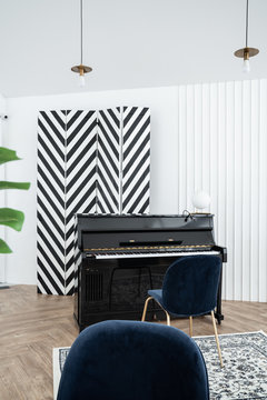 Piano corner scene with chevron black and white stripe partition standing on herringbone wood pattern floor / modern classic interior / musical instrument /minimal classic theme