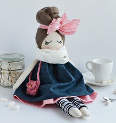 Wall Mural - Handmade rag doll with pale cute pink bow, wearing navy dress and white scarf