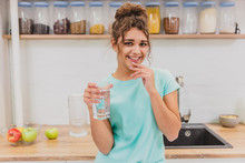 Gorgeous, Beautiful, Young Woman Holding Glass Of Fresh Water And Smiling