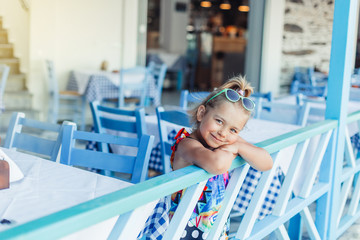 Cheerful little kid smiling and have a good time outdoors in summer. Childhood concept