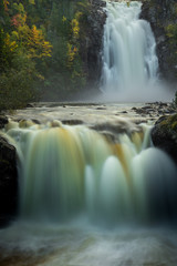 Wall Mural - Big waterfalls in the forest. Autumnal landscape from Norway.