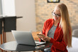 © Pixel-Shot - Beautiful young woman working on laptop in cafe