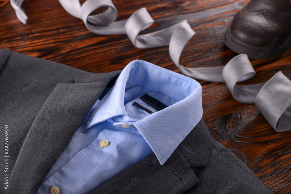 Stylish men's clothes on wooden background