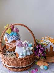 Easter, Easter cake on a light background with a complex composition, beautiful scenery, dried fruits, movement, hands. Traditional Kulich, Paska Easter Bread.