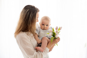 Poster - Cute baby boy,  holding bouquet of fresh tulips for mom