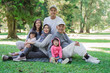 © Odua Images - portrait of family with parent, grandparent and grandchildren together relaxing in the park