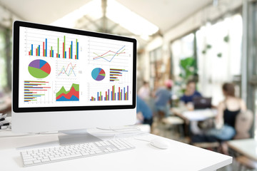 Poster - Modern computer with keyboard and mouse on white table showing charts and graph on screen against lifestyle cafe coffee background , Analysis Business, Statistics Concept