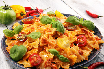 Wall Mural - farfalle. Delicious creamy Italian penne pasta starter with pepper seasoning and fresh basil viewed from above on rustic