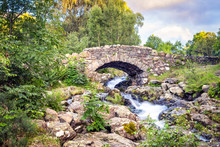 View Of Stone-built Ashness Bridge Over Stream In Lake District.
