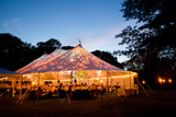 Fototapeta  - Wedding tent at night - Special event tent lit up from the inside with dark blue night time sky and trees