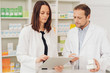 © contrastwerkstatt - Concerned pharmacists checking medicines