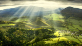 Fototapeta Na ścianę - Landscape and nature in the spring. Landscape with dramatic sky and green meadows. The sun rays through the clouds.