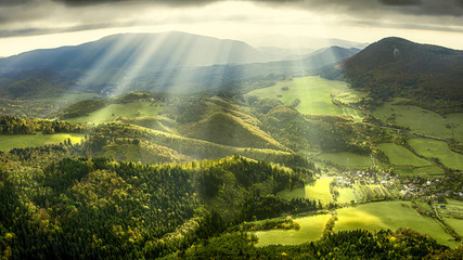 landscape and nature in the spring. landscape with dramatic sky and green meadows. the sun rays thro