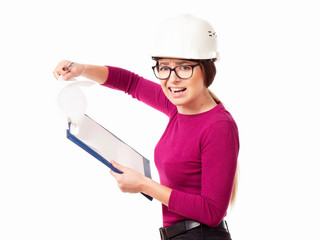 Emotional girl brigadier in a white helmet with glasses and a folder in his hands on a white background