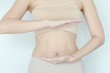 Close up of a cute slim pregnant woman belly with hand on it