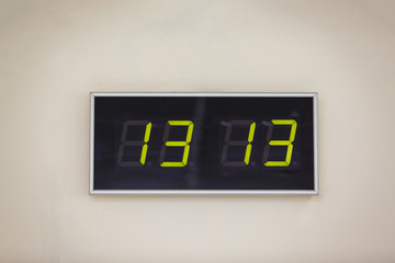 Black digital clock on a white background showing time twelve hours twelve minutes