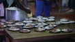© sqofield135178 - Close-up view of African hands putting rise in plates. Dinner for big group of people.