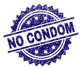 Sticker - NO CONDOM stamp seal watermark with distress style. Blue vector rubber print of NO CONDOM caption with scratched texture.